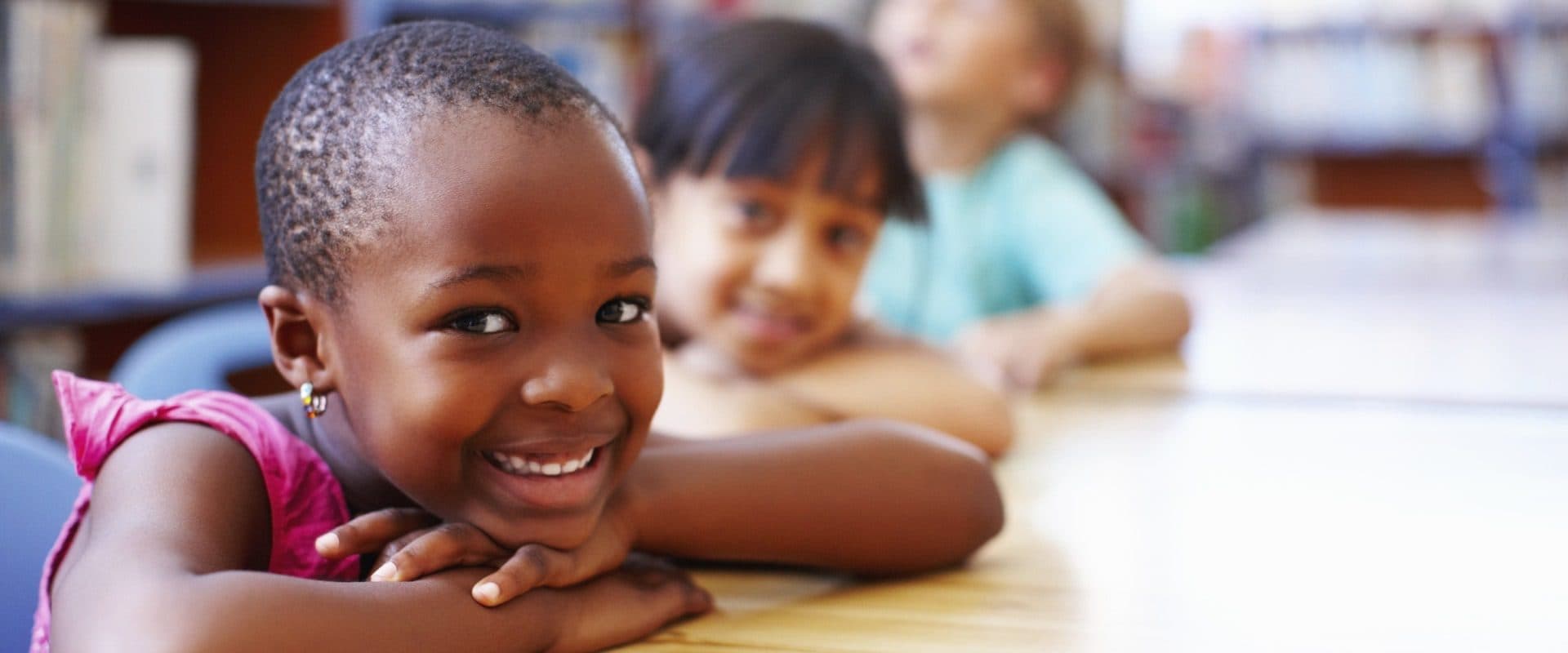 Smiling children sitting together at a Kid's Country table