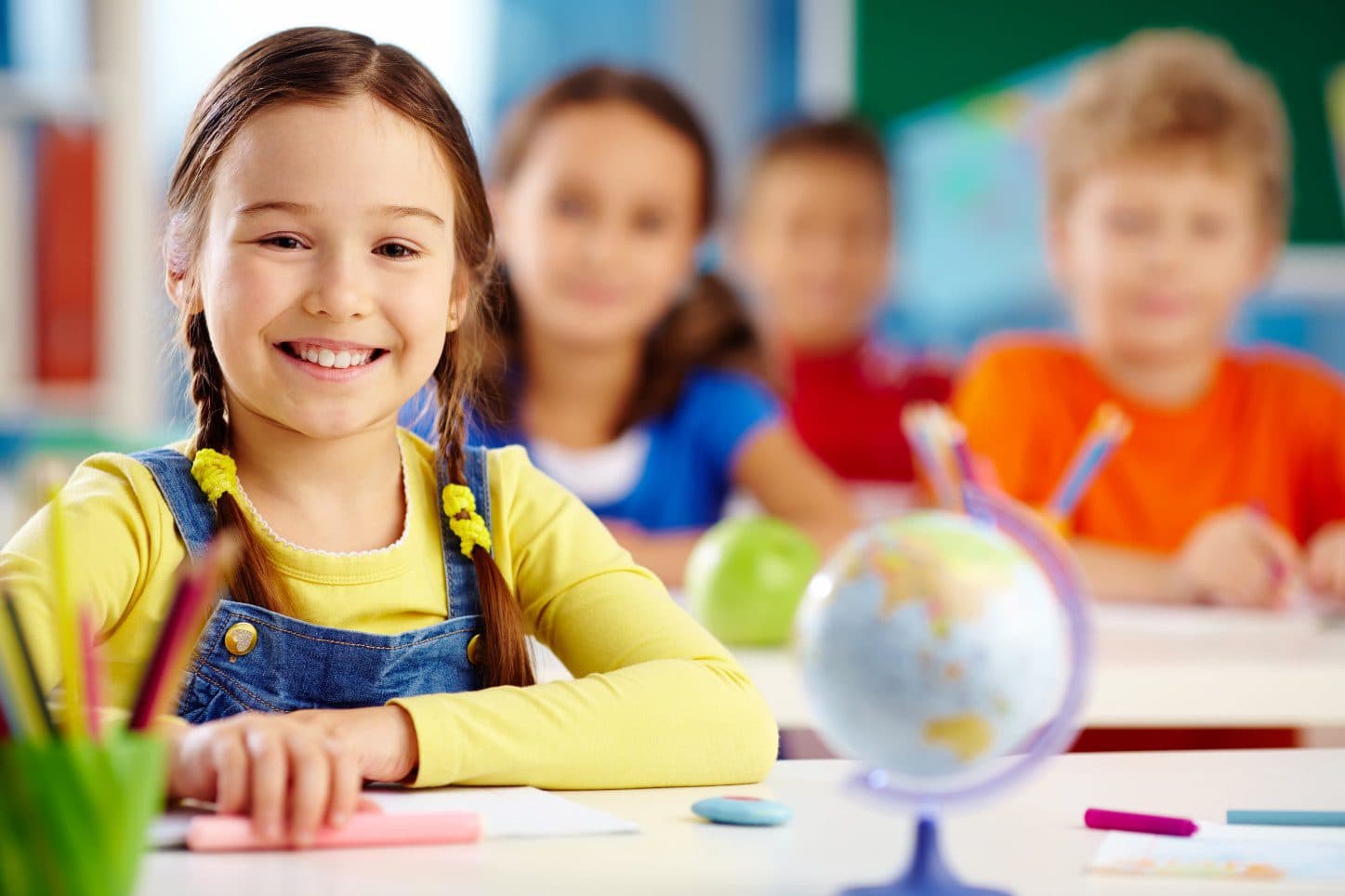 A smiling student in a Kid's Country classroom